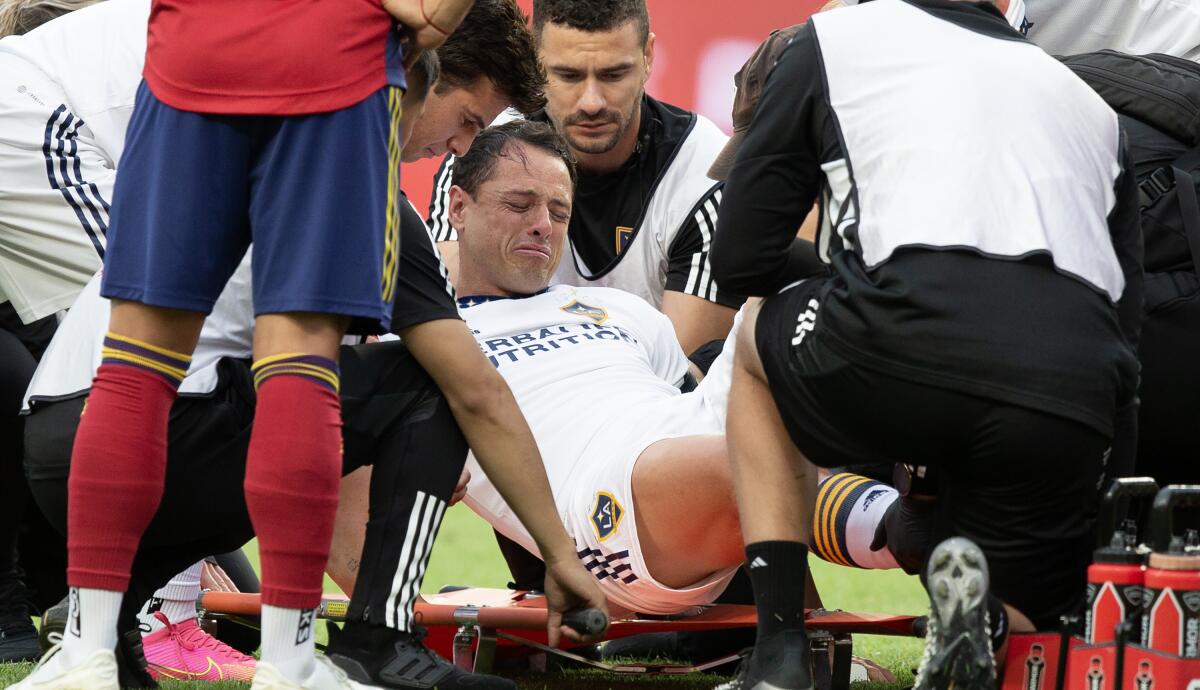 Galaxy's Javier "Chicharito" Hernández reacts while being loaded onto a stretcher after injuring his knee.