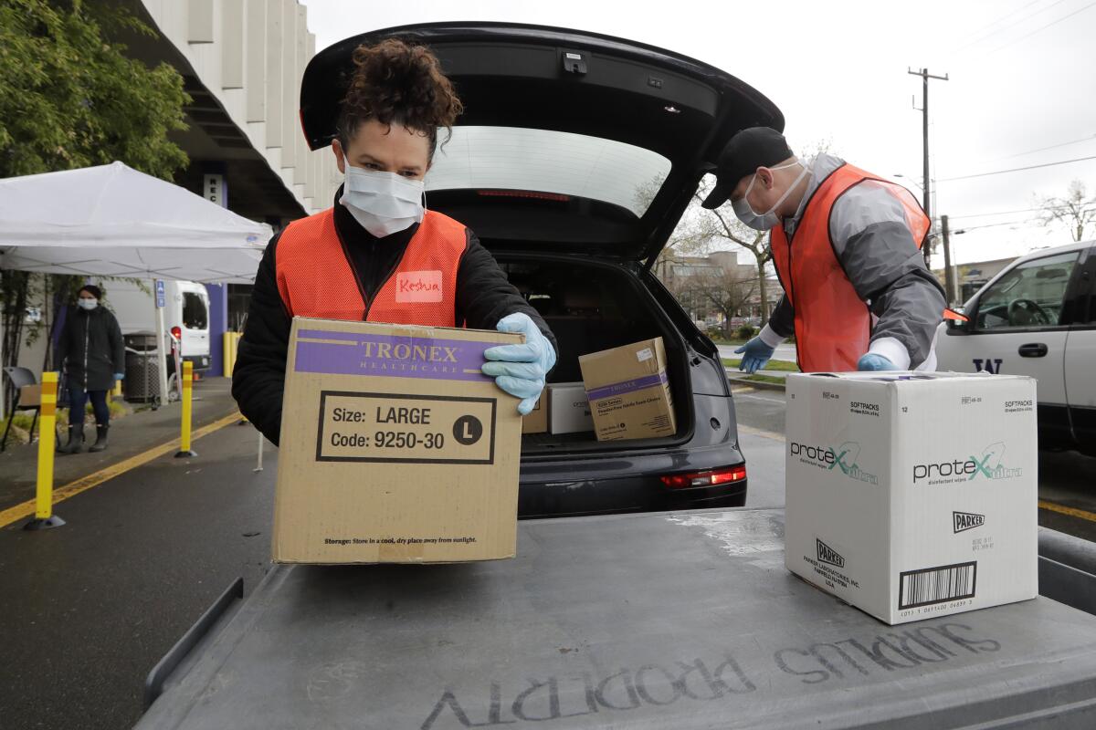Volunteers unload boxes of donated gloves at the University of Washington