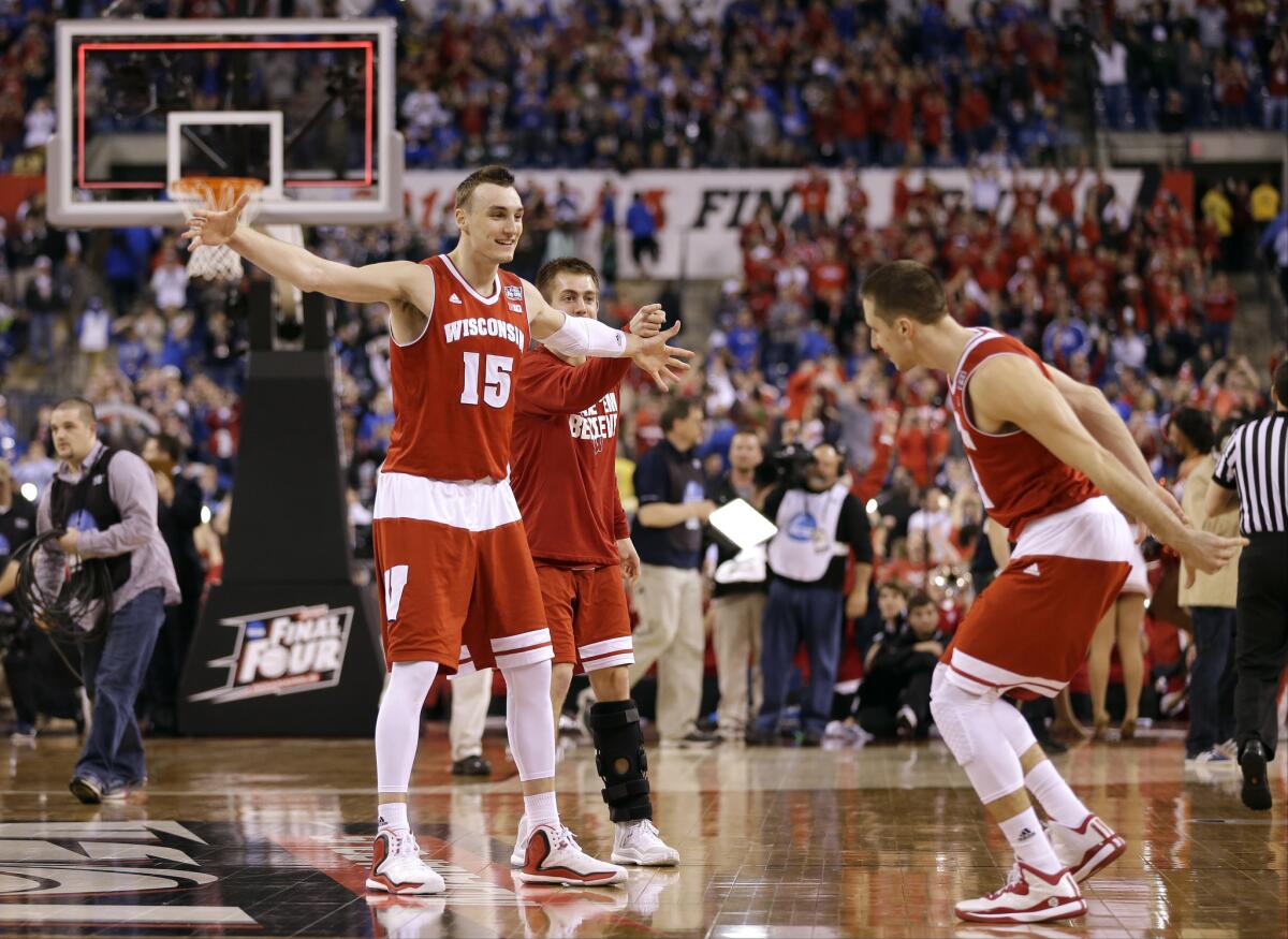 Wisconsin forward Sam Dekker (15) celebrates with teammate Josh Gasser after the Badgers defeated Kentucky, 71-64, in the Final Four on Saturday night in Indianapolis.