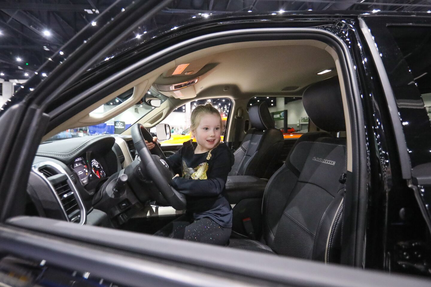 Brenley Trimpi, 5, from El Cajon, sits in the cab of a 2020 Ram 1500 Bighorn Crew Cab 4x4 pickup truck during the 2020 San Diego International Auto Show, January 4, 2020 at the San Diego Convention Center.
