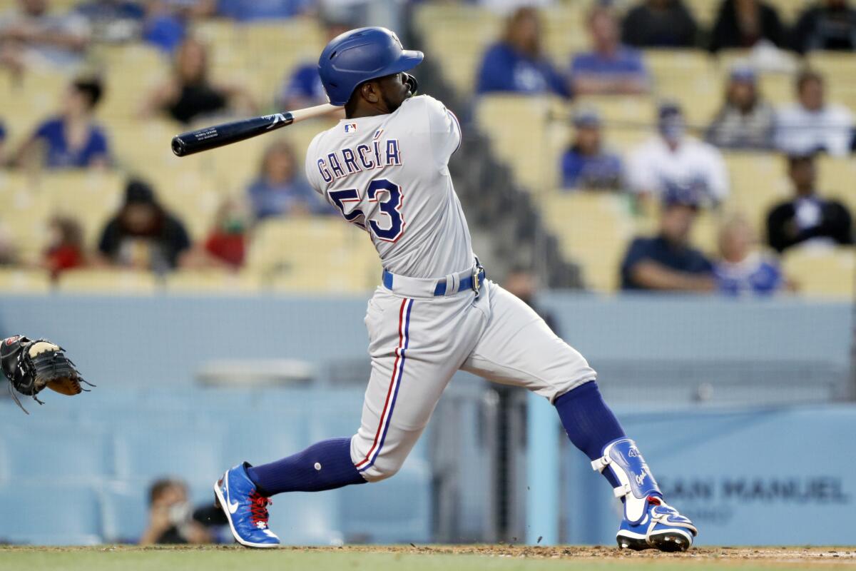 Adolis Garcia follows through on a run-scoring double in the third inning for the Texas Rangers on Saturday.