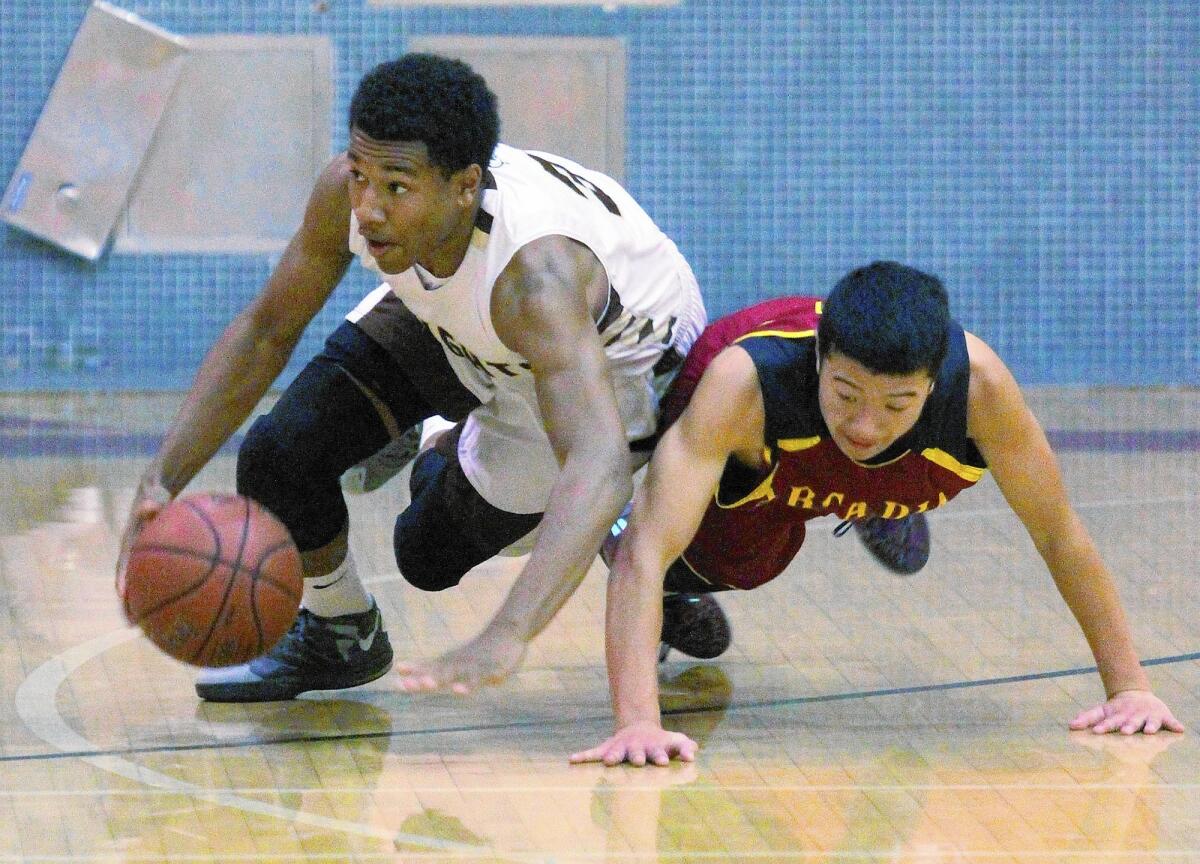 St. Francis' Kyle Leufroy dives for and gets a loose ball against Arcadia's Brendan Tran in the La Cañada Holiday Classic boys basketball tournament at La Cañada High School on Tuesday, December 17, 2013.