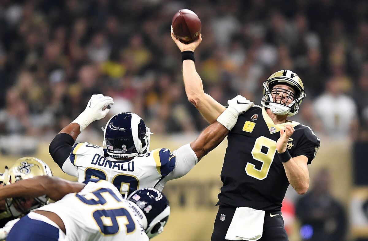 The Rams' Aaron Donald gets an arm on New Orleans Saints quarterback Drew Brees at the Mercedes Benz Superdome in New Orleans on Sunday.