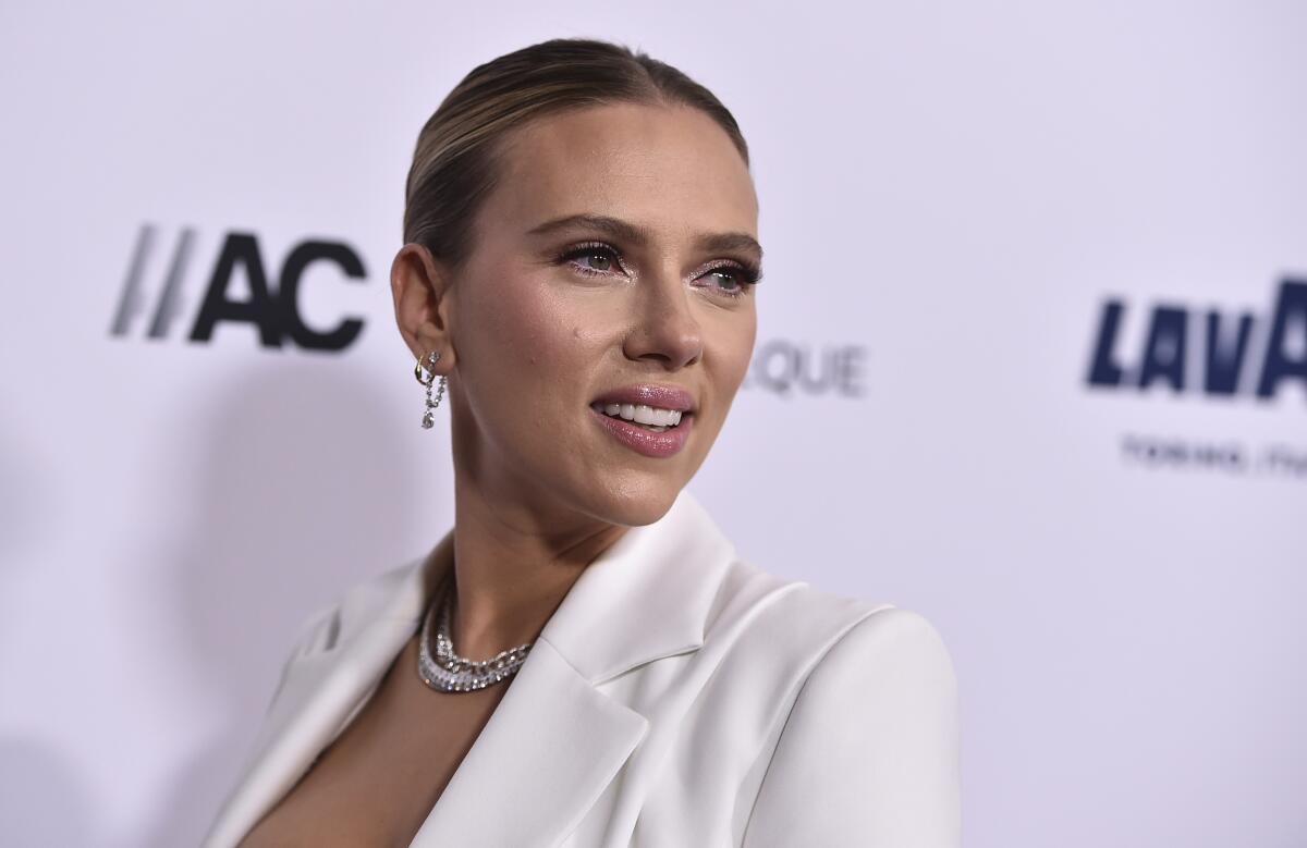 Scarlett Johansson wearing a white blazer.