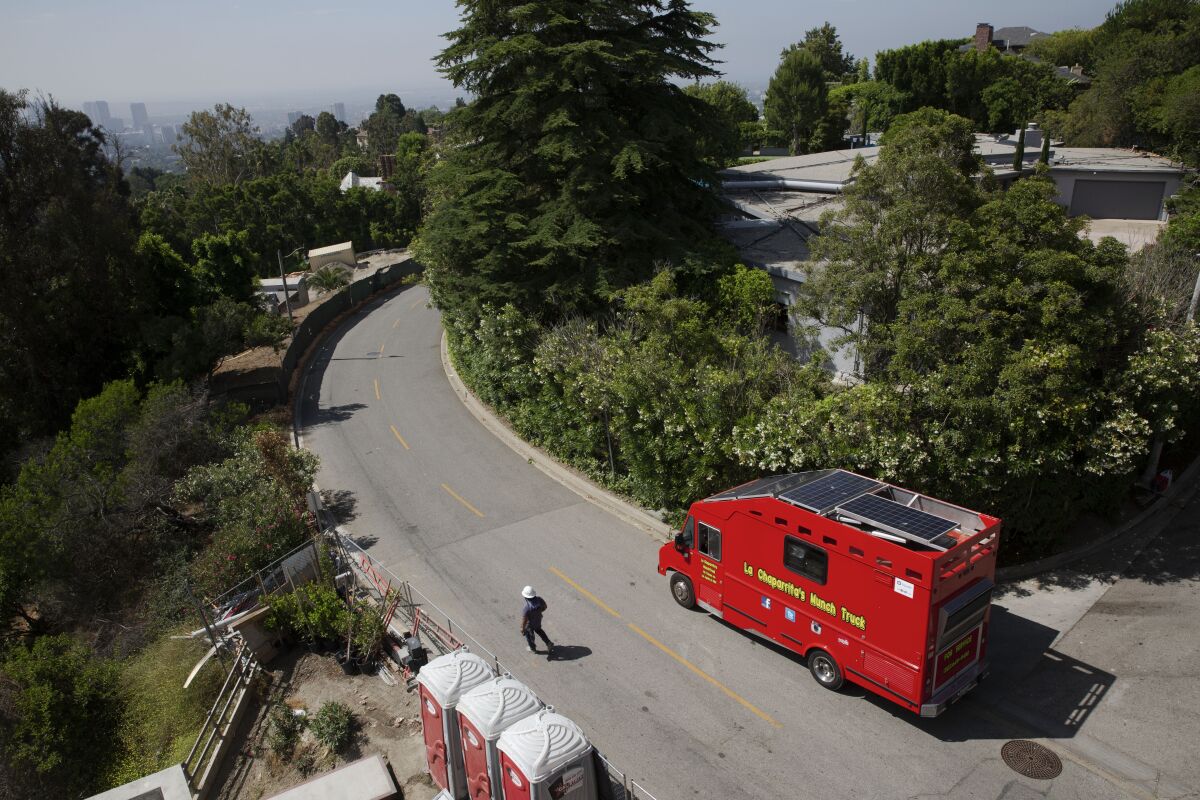A construction worker passes by Jennifer Ramirez food truck in Bel Air.