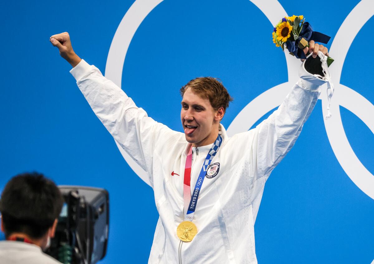 U.S. swimmer Chase Kalisz celebrates on the podium after winning gold.