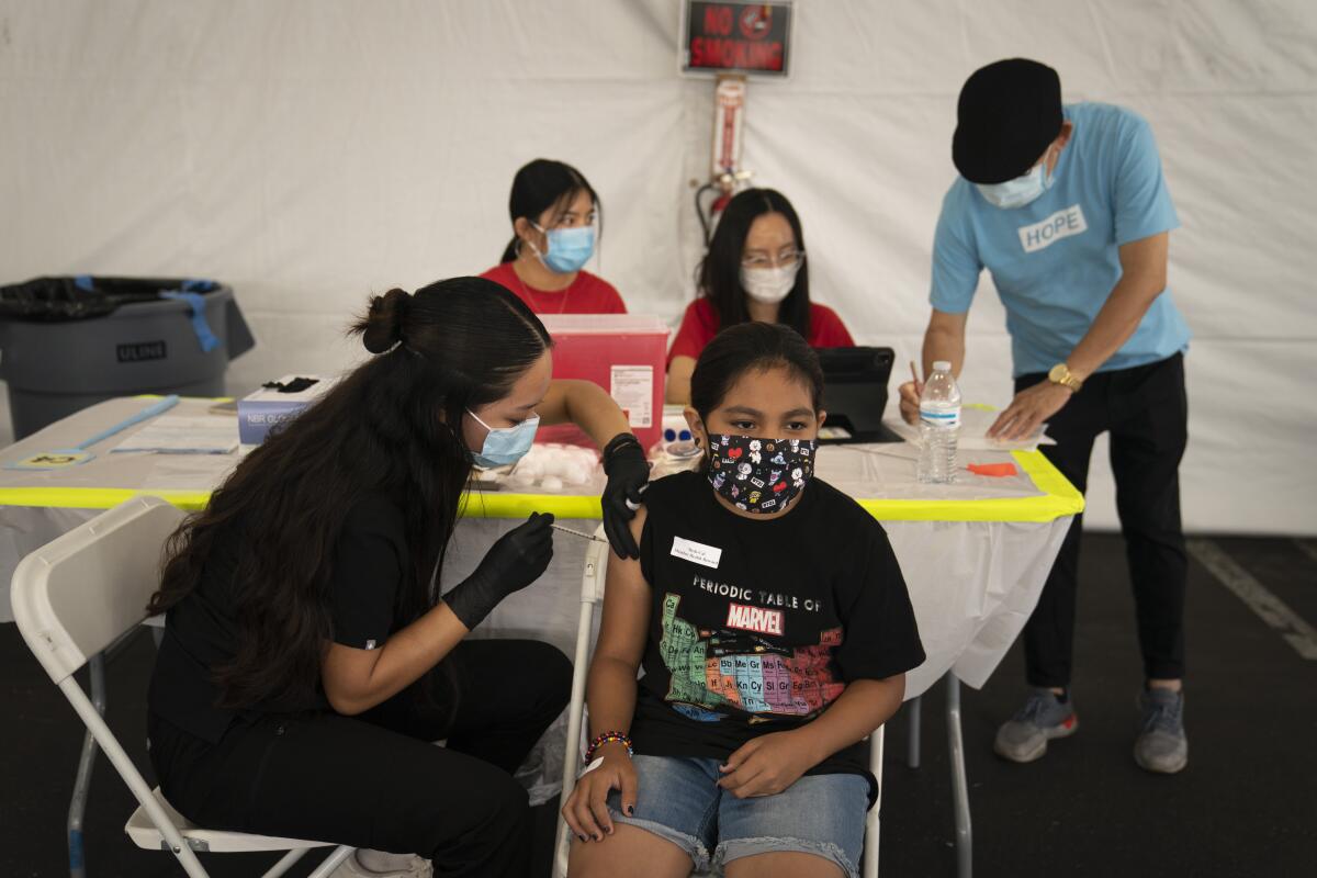 A teenager receives a COVID-19 vaccine.