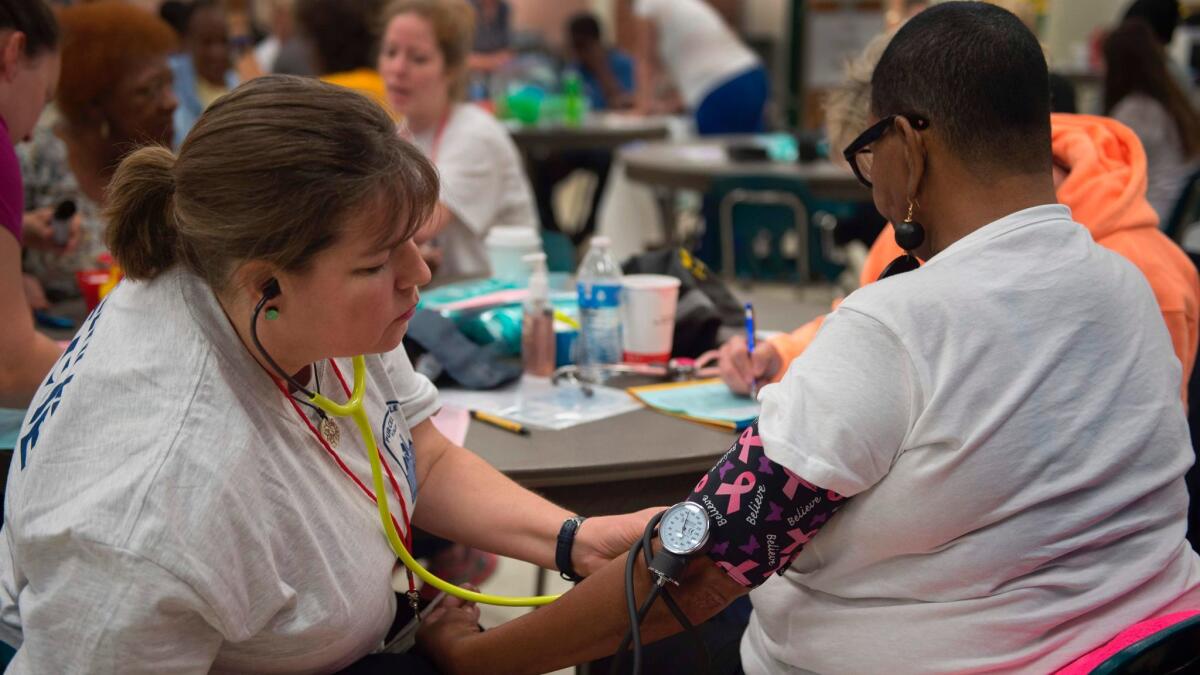 A nurse checks the blood pressure of a patient in Emporia, Va.