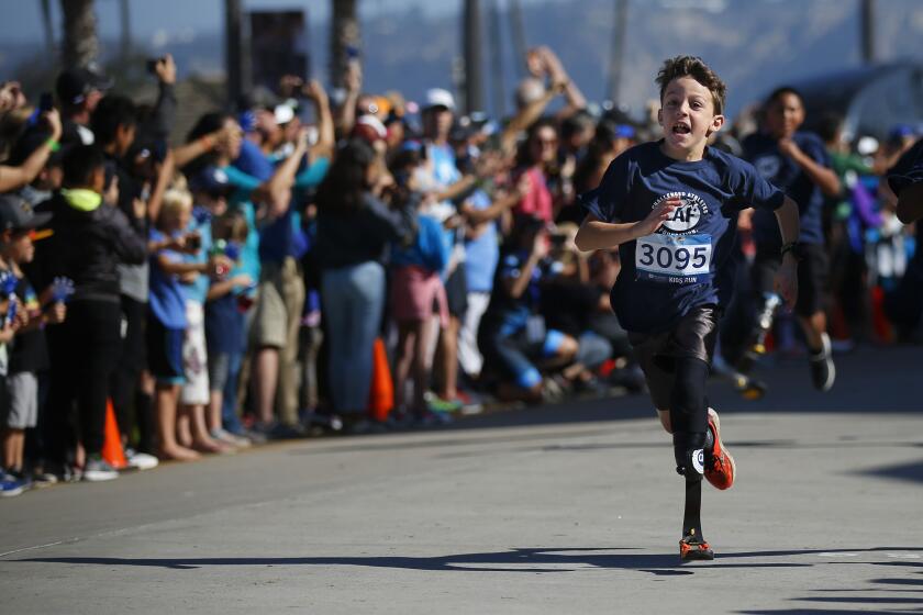 Logan Seitz (3095) runs in the Kid’s Run during the Challenged Athletes Foundation San Diego Triathlon Challenge in La Jolla on Oct. 20, 2019.