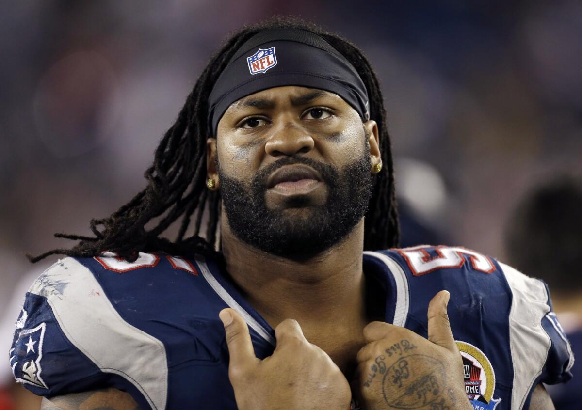 New England Patriots' Brandon Spikes watches from the bench in December 2012.