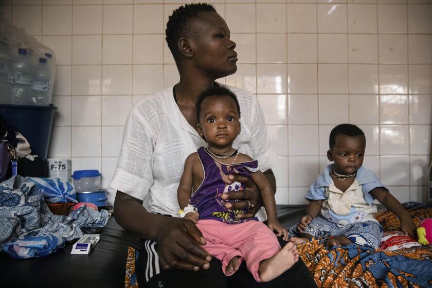 FILE- Malnourished children wait for treatment in the pediatrics department of Boulmiougou hospital in Ouagadougou, Burkina Faso, on April 15, 2022. The United Nations food agency says millions of hungry people in West Africa are left without aid because it is struggling with limited funding to respond to the region's worst hunger crisis in 10 years. In a statement issued Wednesday, July 5, 2023 by the U.N. World Food Program, a top official described the situation in the region as tragic. (AP Photo/Sophie Garcia, File)