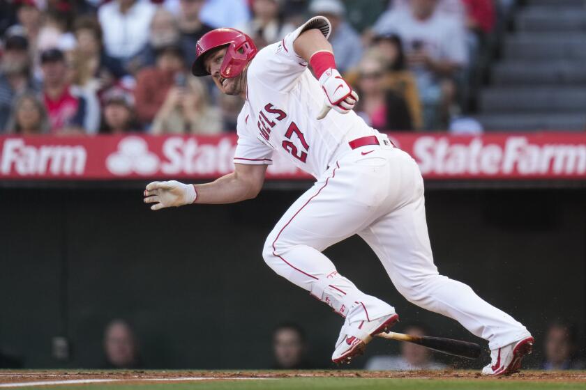 Angels' Mike Trout runs to first base after hitting a single 