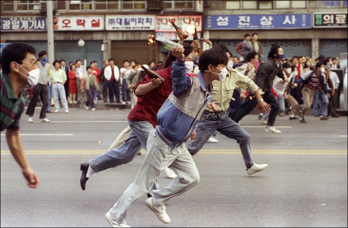 Demonstrators hurl firebombs at police during an anti-government demonstration in downtown Seoul on May 11, 1991.