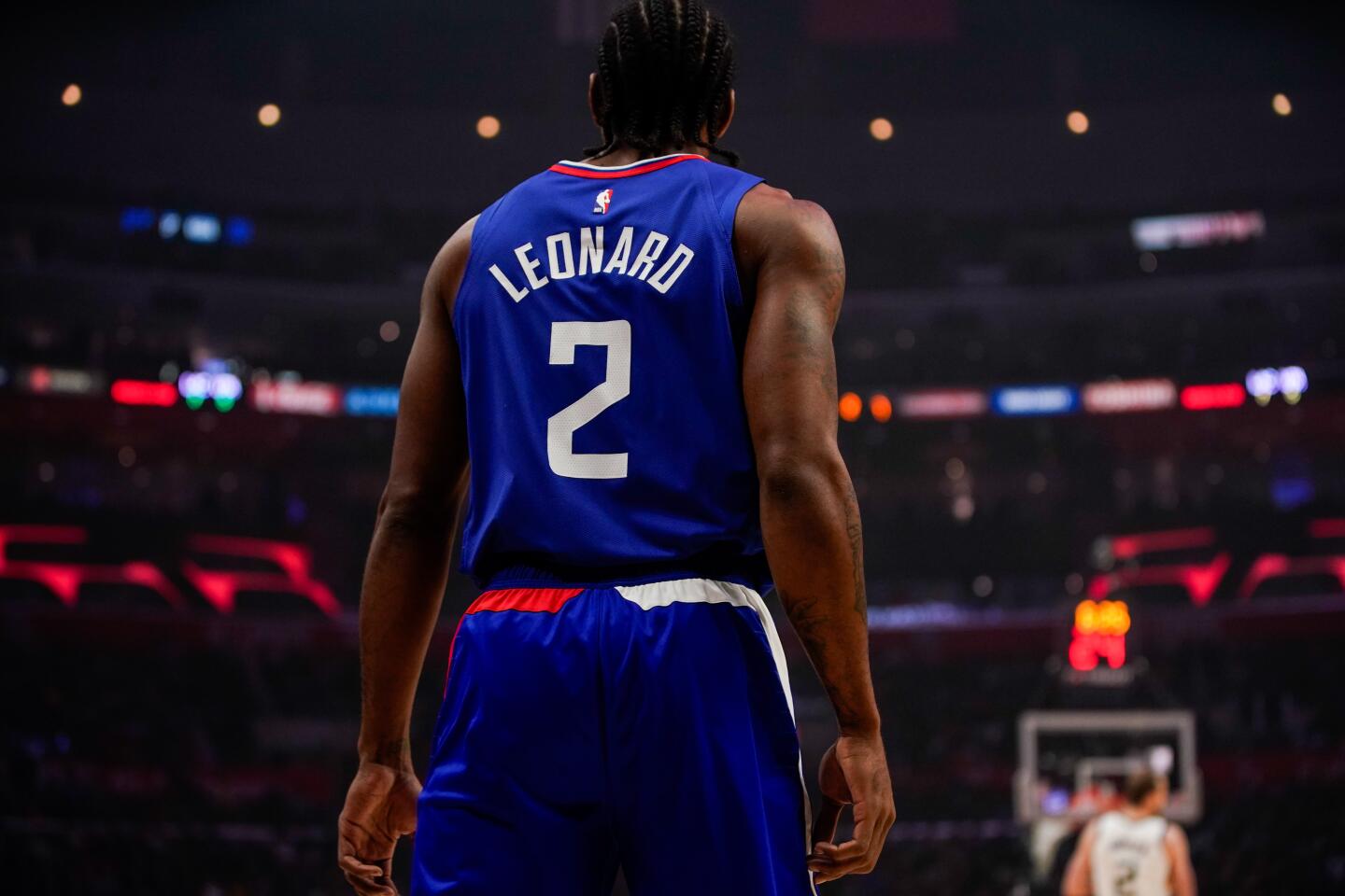 Clippers forward Kawhi Leonard stands on the court.