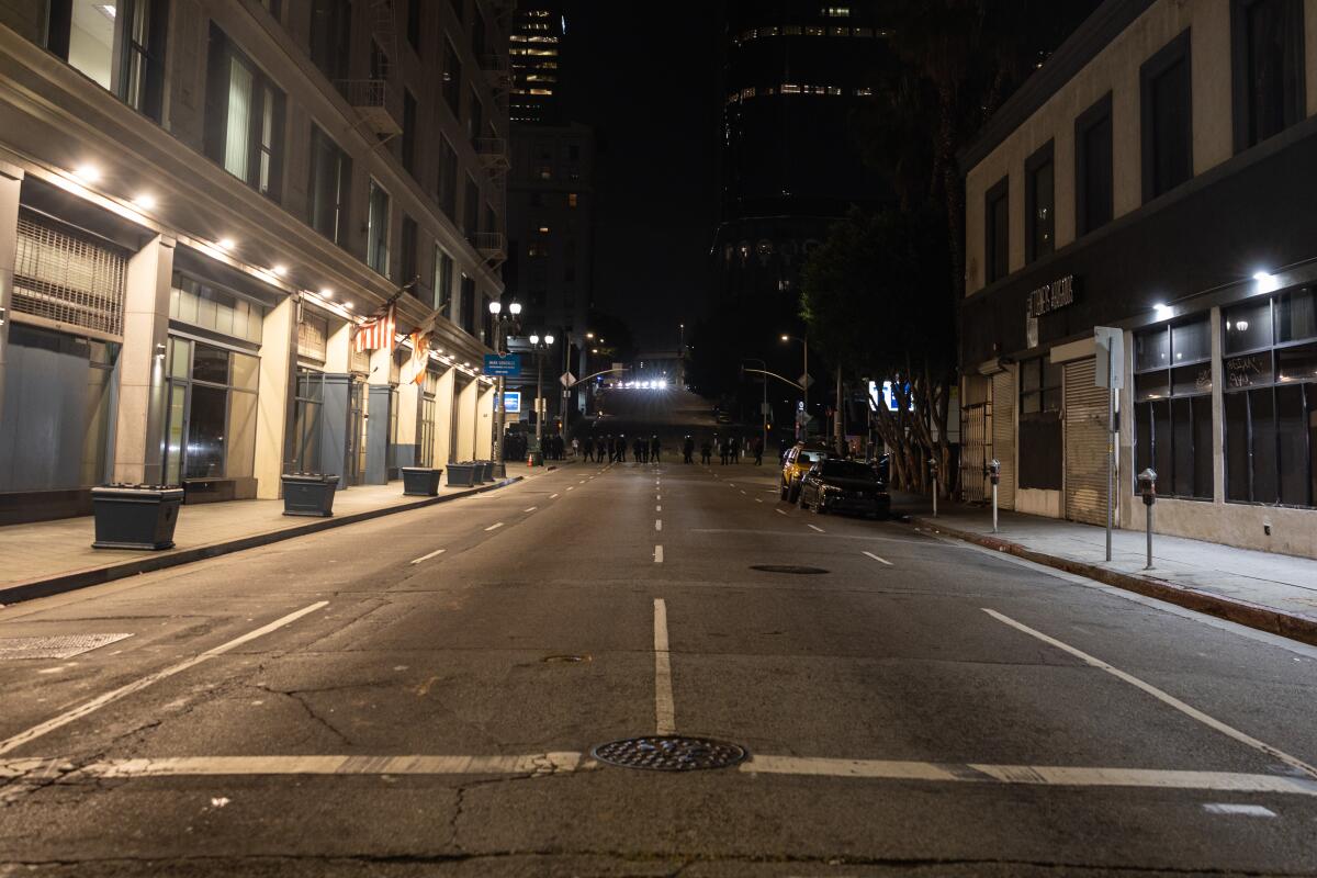 After curfew the LAPD guard the empty streets near City Hall in downtown Los Angeles.