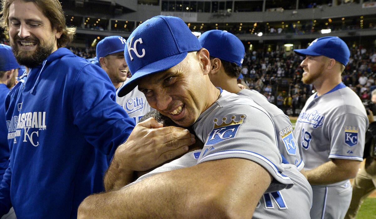 Royals outfielder Raul Ibanez hugs teammate Jarrod Dyson after they clinched a wild-card playoff berth with a victory over the White Sox last month.