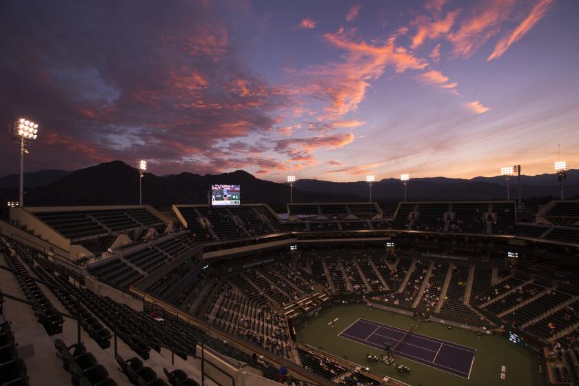 The sun sets behind the mountains as Federico Delbonis of Argentina plays American Ryan Harrison in the first round at the BNP Paribas Open at Indian Wells Tennis Garden in Indian Wells.