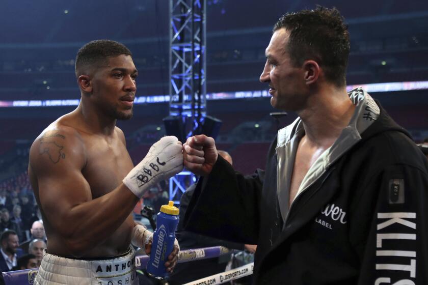 Anthony Joshua and Wladimir Klitschko bump fists after their heavyweight championship bout on Saturday.