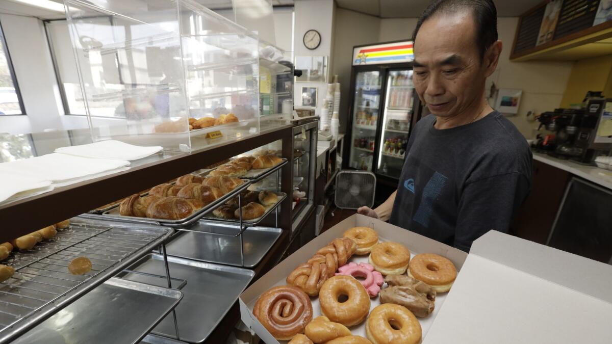 Customers in Seal Beach are buying out all of John Chhan's his fresh-baked doughnuts so that he can leave to be with his wife, Stella, who is in a Costa Mesa nursing home after being diagnosed with a brain aneurysm.