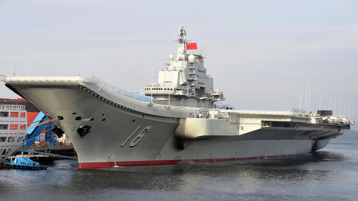 In this undated file photo released by China's Xinhua News Agency, China's aircraft carrier Liaoning berths in a Chinese port. (Li Tang / Xinhua via AP)