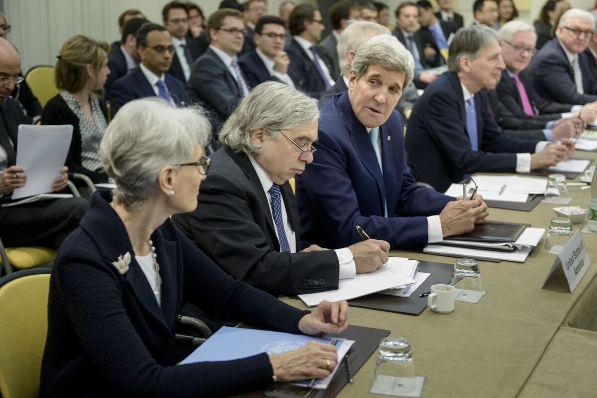 Secretary of State John F. Kerry, third from left, chats with Under Secretary for Political Affairs Wendy Sherman, as Secretary of Energy Ernest Moniz takes a note while waiting for the start of a meeting on Iran's nuclear program.