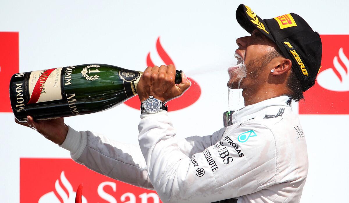 Formula One driver Lewis Hamilton celebrates on the podium after winning the British Grand Prix at Silverstone Circuit on Sunday.