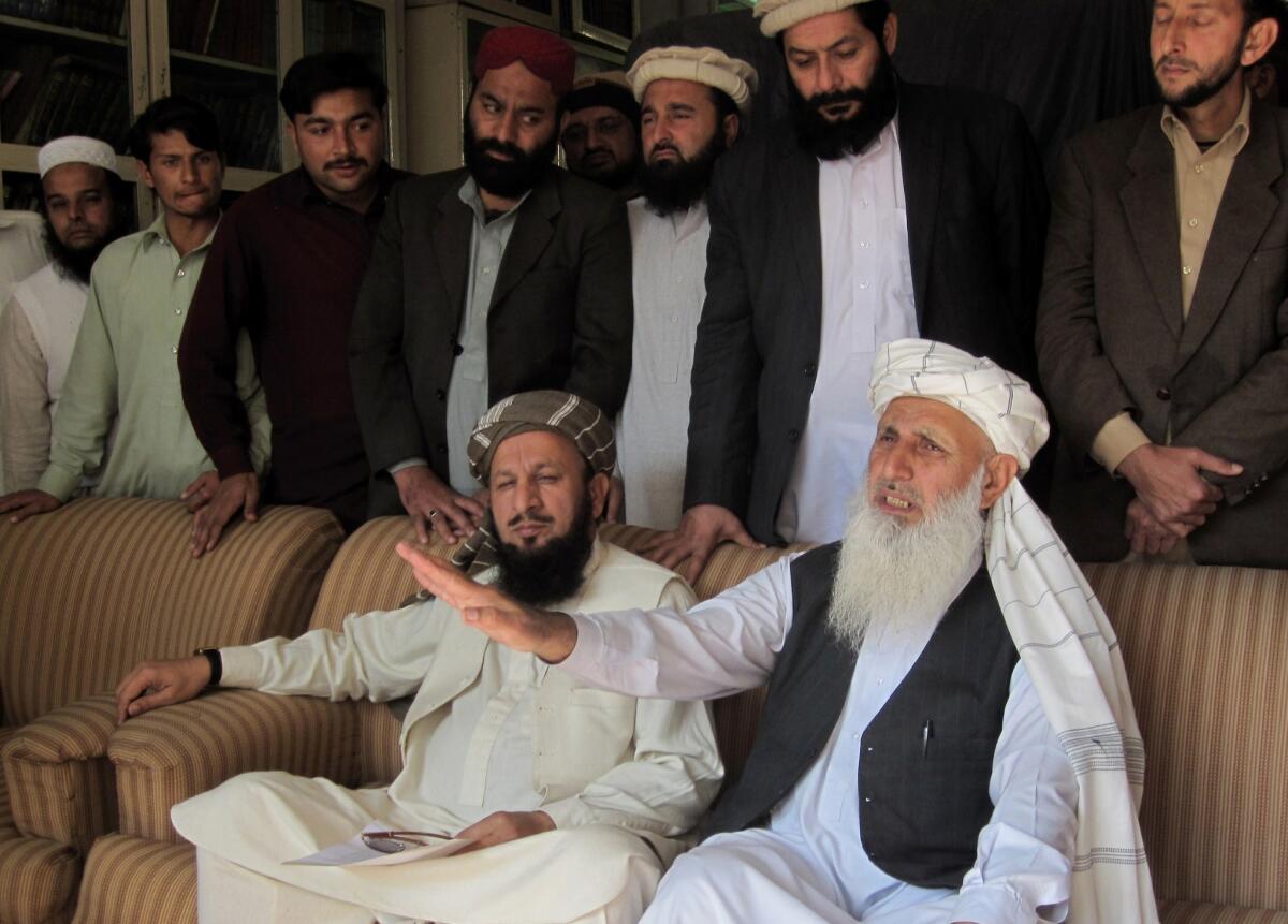 Pakistan Taliban members Ibrahim Khan, right, and Mualana Yousaf Shah, left, speak to media in Akora Khattak on Monday. They are part of a committee nominated to take part in peace talks with the Pakistan government.