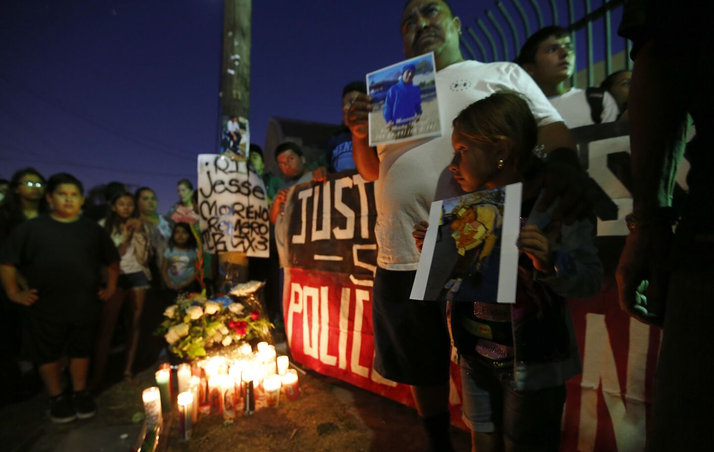 Boyle Heights residents gather near the intersection of Breed Street and Cesar Chavez Avenue on Wednesday night to protest the fatal officer-involved shooting of Jesse Moreno Romero.