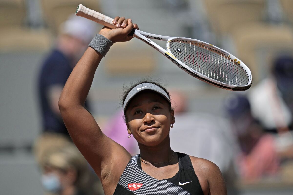 FILE - Japan's Naomi Osaka celebrates after defeating Romania's Patricia Maria Tig during a first-round match of the French Open tennis tournament at Roland Garros stadium in Paris, May 30, 2021. Naomi Osaka pulled out of Wimbledon on Saturday June 18, 2022, citing a lingering problem with her left Achilles tendon, marking the second consecutive year she's decided to sit out the grass-court Grand Slam tournament. (AP Photo/Christophe Ena, File)