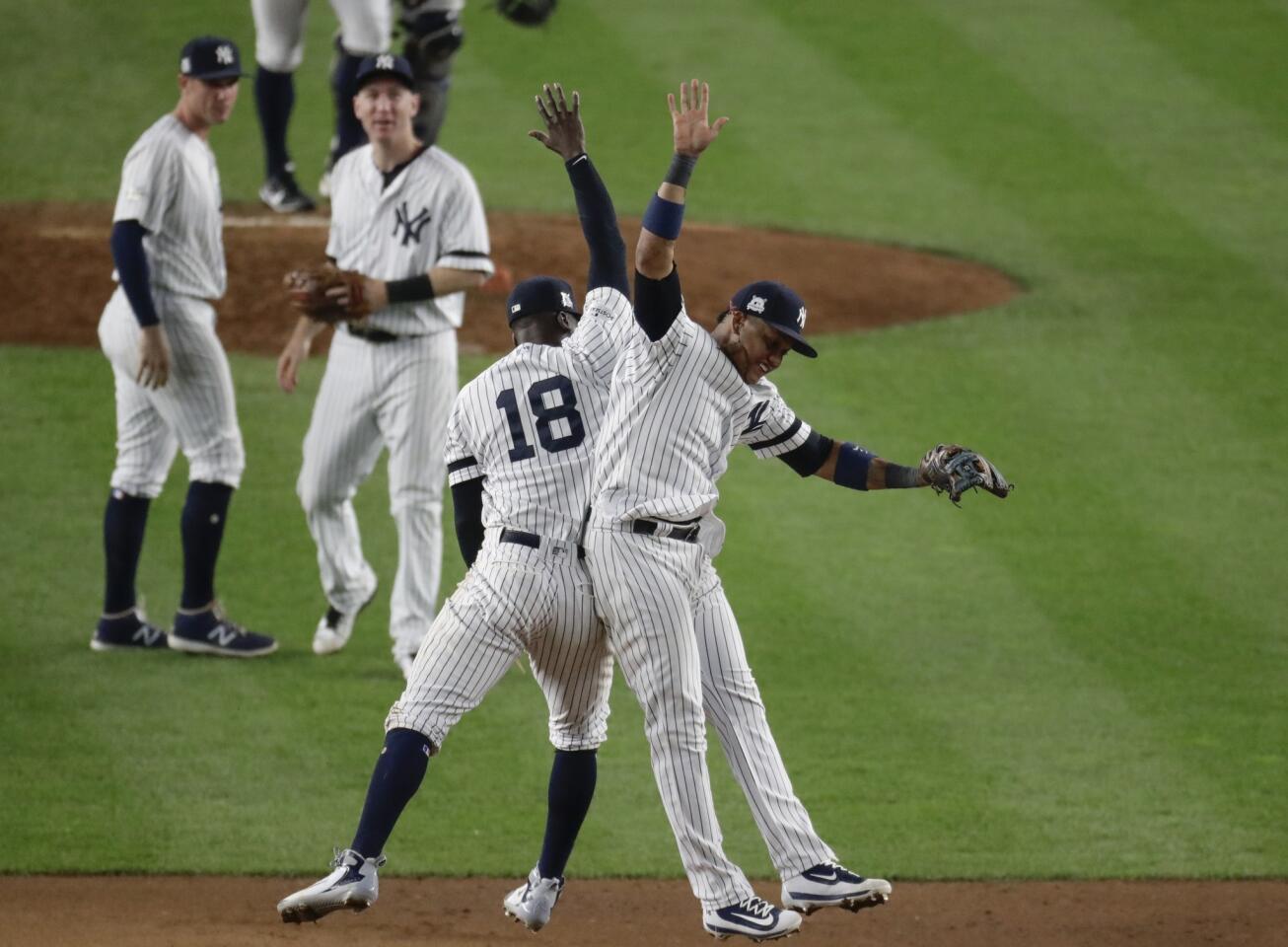 New York Yankees' Didi Gregorius and Starlin Castro celebrate after Game 5 of baseball's American League Championship Series against the Houston Astros Wednesday, Oct. 18, 2017, in New York. The Yankees won 5-0 to take a 3-2 lead in the series. (AP Photo/Frank Franklin II)