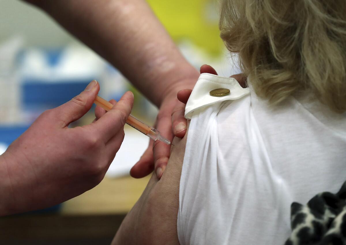 A woman receives a COVID-19 vaccination.