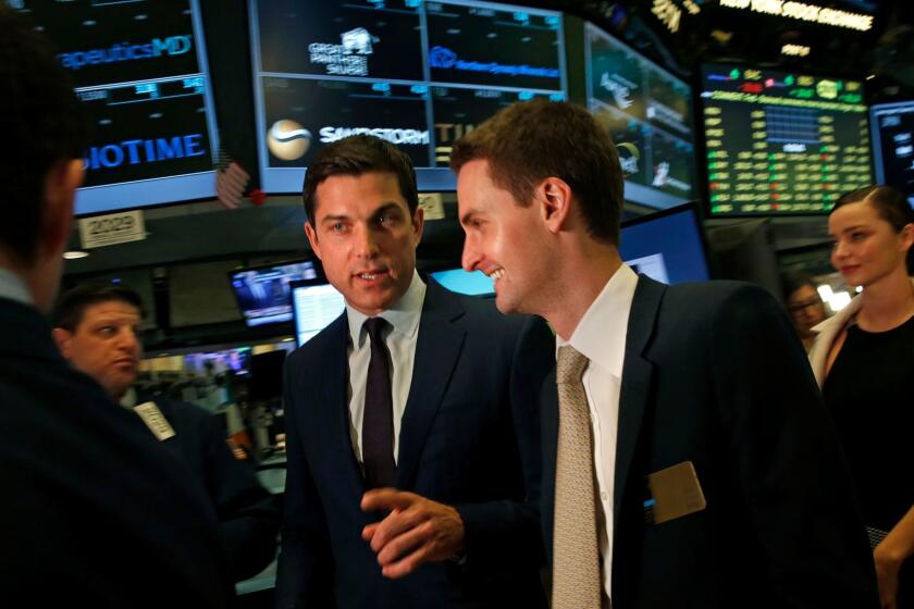 Snap Inc. Chief Executive Evan Spiegel, right, enters the trading floor before he rings the bell at the New York Stock Exchange for its Wall Street debut.
