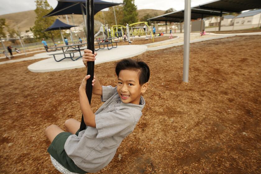 LOS ANGELES, CA - DECEMBER 05, 2019 7-year-old Sawyer Dinh who is a transgender boy plays at the park next to his elementary school in the Oak Park Unified School District in Ventura County which is one of very few districts across the country to teach its elementary-level students lessons on gender diversity. The curriculum was rolled out in October, and some parents weren't happy believing this topic should be discussed at home, if at all. (Al Seib / Los Angeles Times)