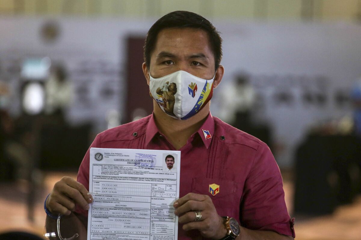 Retired boxer Manny Pacquiao holding certificate of candidacy for Philippine presidency