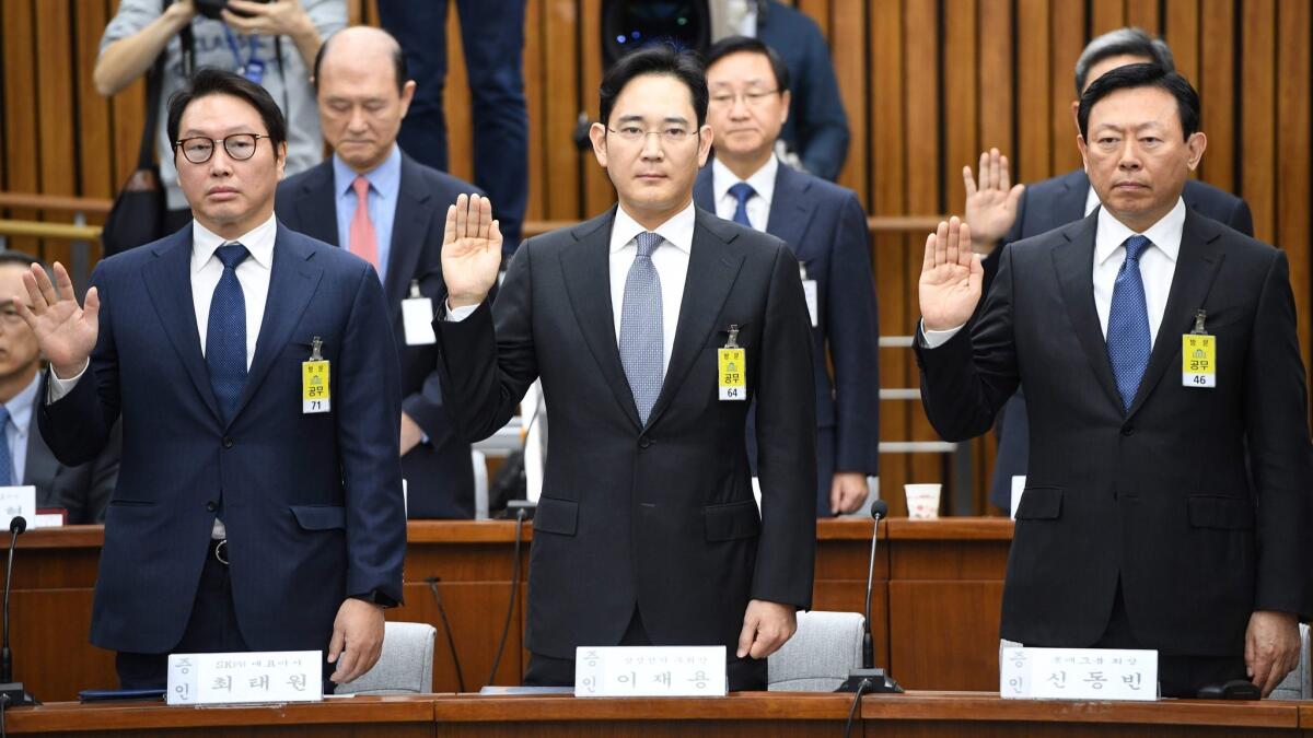 SK Group chairman Chey Tae-won, from left, Samsung Group's Lee Jae-yong and Lotte Group Chairman Shin Dong-bin take an oath in December 2016 during a parliamentary probe into a scandal engulfing then-President Park Geun-hye.
