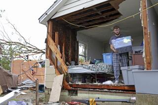 Sean Thomas Sledd salvages items from his room after it was hit by a tornado the night before in Sulphur, Okla., Sunday, April 28, 2024. Sledd sought shelter at Oklahoma School for the deaf. (Bryan Terry/The Oklahoman via AP)