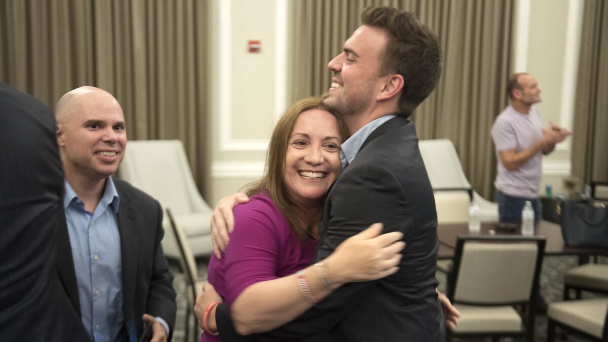 Lori Alhadeff and her finance director, Sam Cook, celebrate her lead in election returns Tuesday.