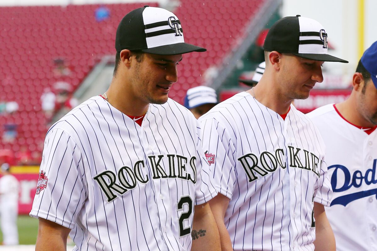Troy Tulowitzki of the Colorado Rockies and his teammate Nolan Arenado, right, walk off the field at the Great American Ballpark in Cincinnati before the 2015 MLB All-Star game on July 14.