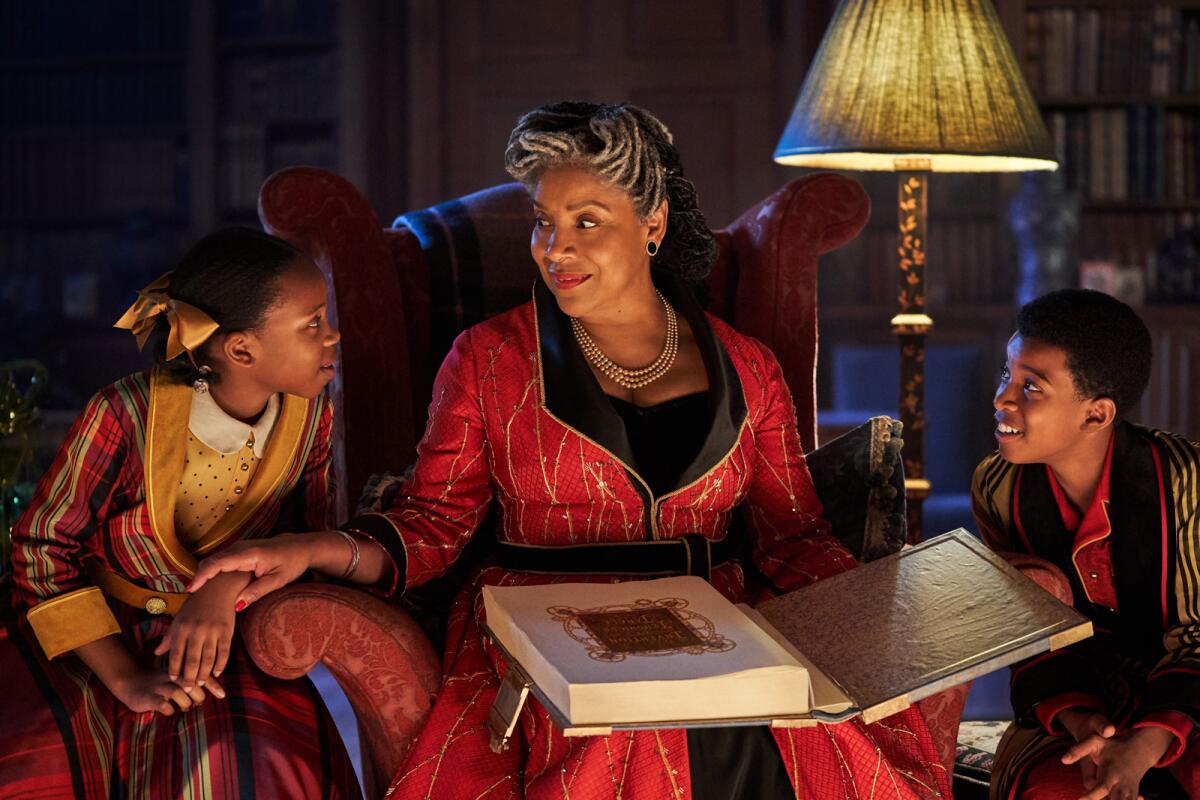 Phylicia Rashad reads to Ria Calvin, left, and Kenyah Sandy in the movie "Jingle Jangle: A Christmas Journey."