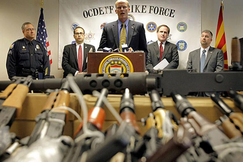 Bill Newell, special agent in charge of ATF Phoenix, speaks behind a cache of seized weapons in Phoenix. The ATF is under fire over a Phoenix-based gun-trafficking investigation called "Fast and Furious," in which agents allowed hundreds of guns into the hands of straw purchasers in hopes of making a bigger case.
