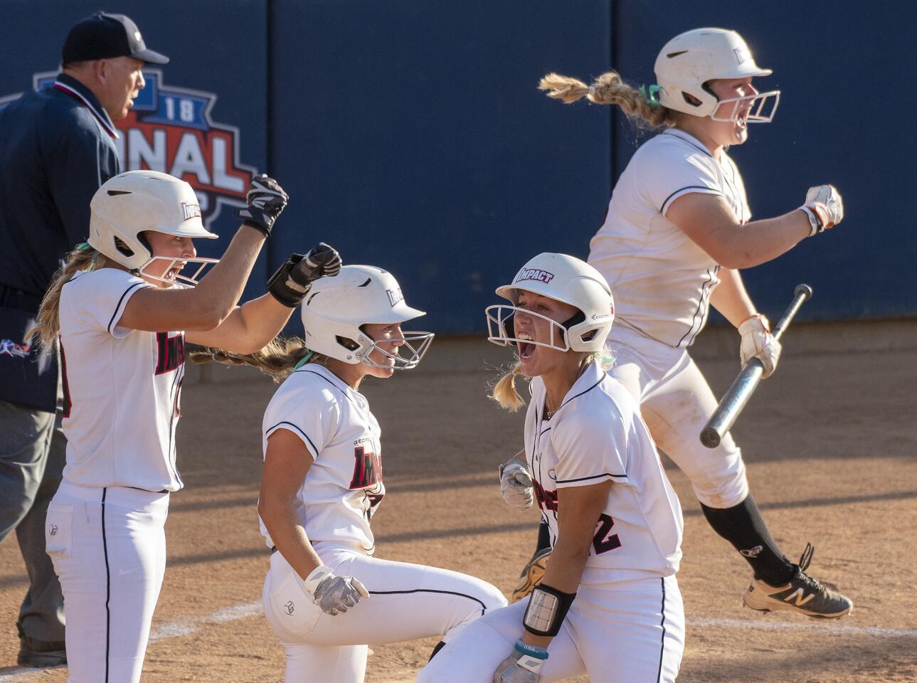 Georgia Impact players celebrate after Charla Echols hits a three run double in the sixth inning in the 18U Premier bracket championship game of the PGF Nationals on Friday, July 27.