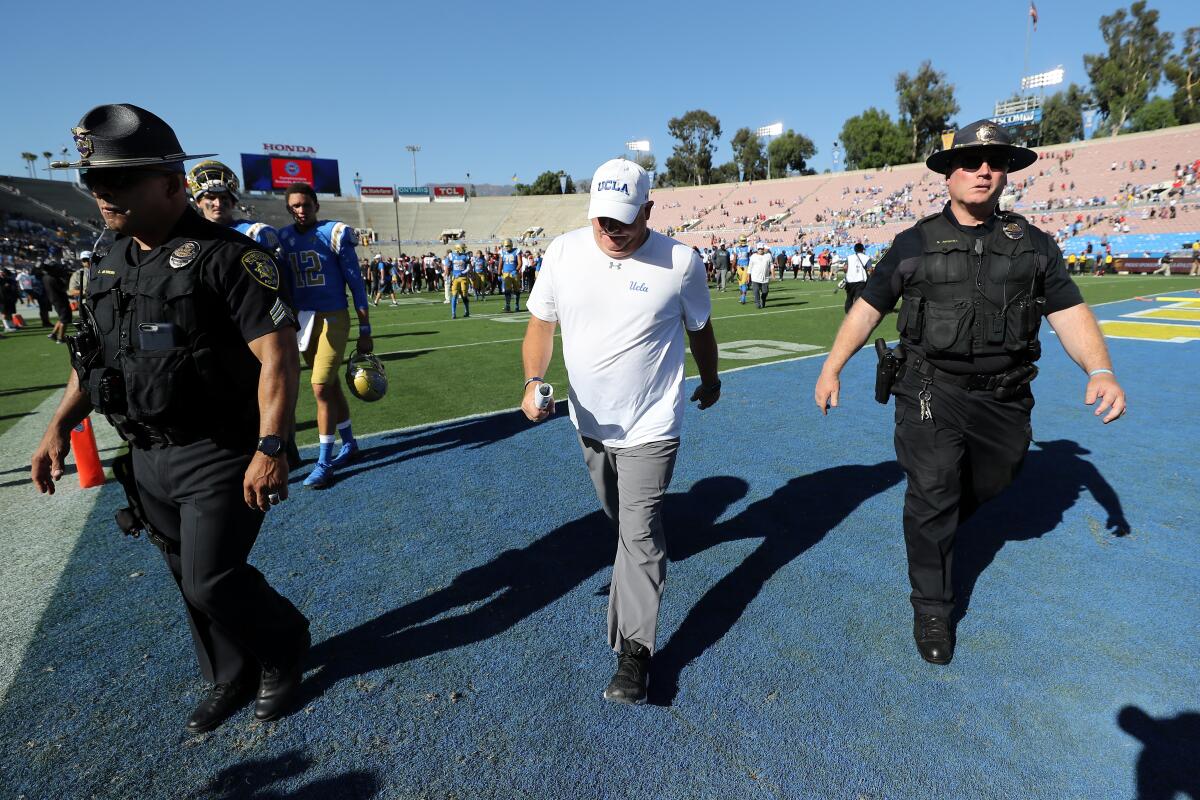 UCLA coach Chip Kelly walks off the field following Saturday's loss to San Diego State at the Rose Bowl.