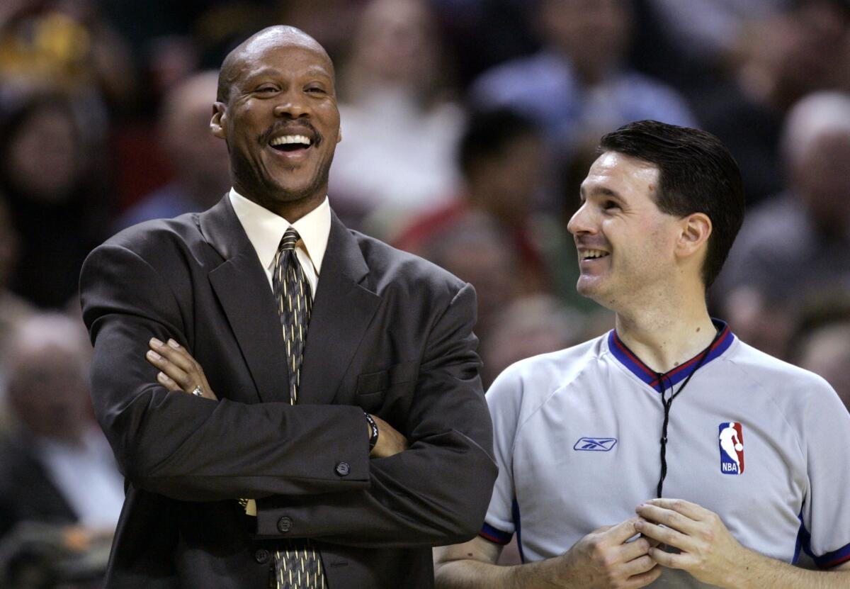New Orleans Hornets Coach Byron Scott, left, shares a laugh with referee Pat Fraher during a game against the Seattle SuperSonics in 2005.