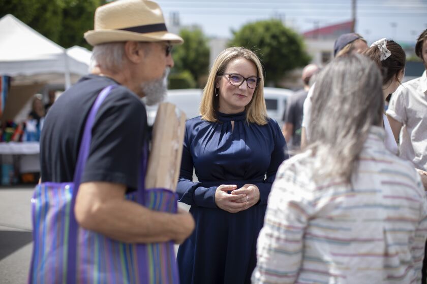 LOS ANGELES, CA - APRIL 10: Lindsey Horvath, who is running for supervisor in Los Angeles County's District 3, meets with Joe LaRusso and wife Eileen at the Melrose Place Farmers Market on Sunday, April 10, 2022. Their concerns were about public safety and about West Hollywood being turned into a "pot party town." (Myung J. Chun / Los Angeles Times)