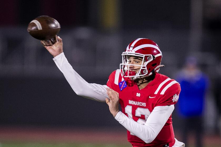 Mission Viejo, CA - December 11: Mater Dei quarterback Elijah Brown throws the ball against San Mateo Serra defenders in the fourth quarter, part of the 2021 CIF State Football Championship Bowl Games - Open Division tournament in Saddleback College, Mission Viejo, CA on Saturday, Dec. 11, 2021. (Allen J. Schaben / Los Angeles Times)