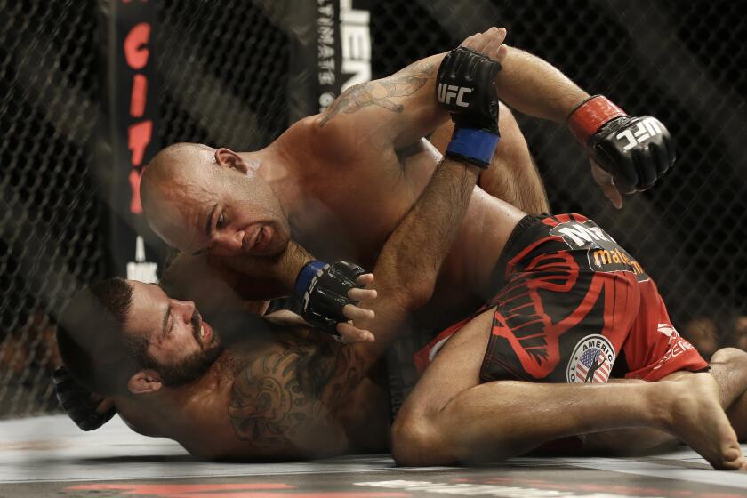 Robbie Lawler, top, grapples with Matt Brown during a welterweight mixed martial arts bout at a UFC on July 26. Lawler won by unanimous decision.