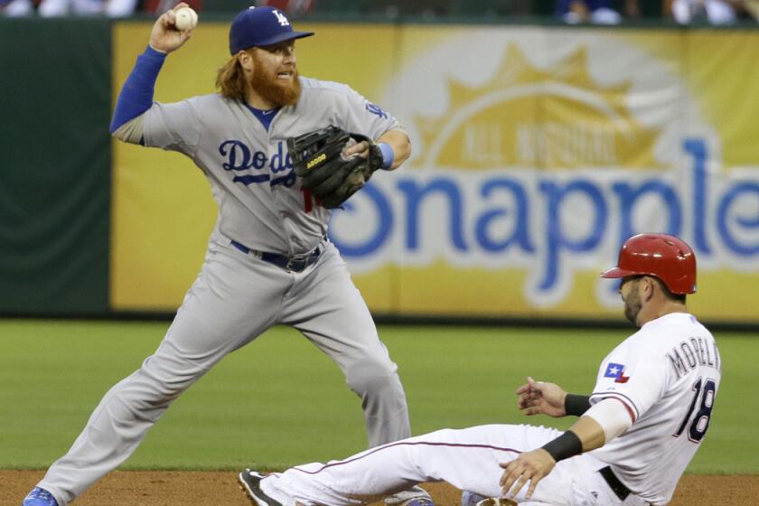 Dodgers third baseman Justin Turner throws from second base for the double play attempt as the Texas Rangers' Mitch Moreland slides after being forced out during the fourth inning Tuesday.