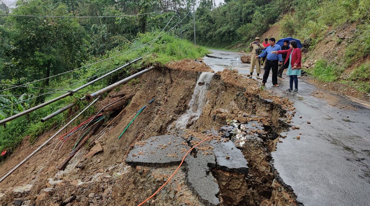 People inspect the area of a landslide after heavy rainfall in Dima Hasao district, in the northeastern Indian state of Assam, Monday, May 16, 2022. At least eight people have died in floods and mudslides triggered by heavy rains in India’s northeast region, officials said Tuesday. (Dima Hasao district administration via AP)