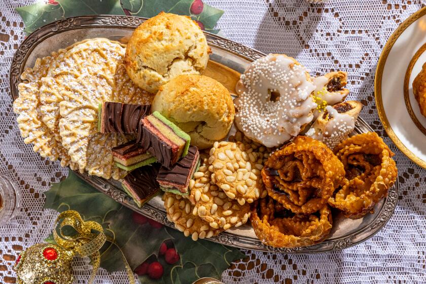 LOS ANGELES, CA - NOVEMBER 14, 2023: A selection of Italian holidday cookies from the members of the Garibaldina Society - clockwise from the left, pizzelle, "brick" cookies, cuccidati, cartellate, pignoli, and "Versace" rainbow cookies photographed on Tuesday, Nov. 14, 2023, at the Garibaldina Society in Los Angeles, CA. (Silvia Razgova / For The Times)