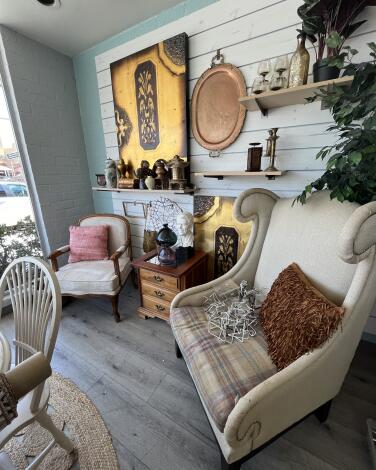 Two chairs and assorted housewares in a thrift store 